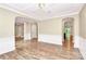 Open living room with archways, decorative ceilings, and beautiful hardwood floors at 11052 Preservation Park Dr, Charlotte, NC 28214