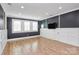 Spacious living room with wainscoting, hardwood floors, and natural light at 11052 Preservation Park Dr, Charlotte, NC 28214