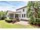An exterior view of the home featuring a screened porch and patio, as well as well-maintained landscaping at 11052 Preservation Park Dr, Charlotte, NC 28214