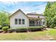 An exterior view of the home featuring a screened porch, well maintained landscaping, and a stone walkway at 11052 Preservation Park Dr, Charlotte, NC 28214