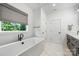 Bright bathroom features a soaking tub with black fixtures and white marbled floors at 1149 Rosecliff Dr, Waxhaw, NC 28173