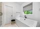 Clean bathroom with a soaking tub, a black faucet and a window at 1149 Rosecliff Dr, Waxhaw, NC 28173