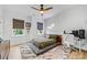 Cozy bedroom with a ceiling fan, two windows and a light colored carpet at 1149 Rosecliff Dr, Waxhaw, NC 28173
