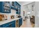 Elegant butler's pantry featuring custom blue cabinetry, wine storage, and quartz countertops at 1149 Rosecliff Dr, Waxhaw, NC 28173