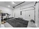 Garage features gym equipment, painted epoxy floor, and ample natural light at 1149 Rosecliff Dr, Waxhaw, NC 28173