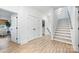 Bright hallway with stairwell and decorative doors, offering a glimpse into the home's layout at 1149 Rosecliff Dr, Waxhaw, NC 28173