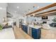 Open concept kitchen with a large island, white cabinets, stainless steel appliances, and beamed ceilings at 1149 Rosecliff Dr, Waxhaw, NC 28173