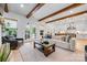 Bright and airy living room featuring wood beams, neutral furniture, and seamless flow to the kitchen at 1149 Rosecliff Dr, Waxhaw, NC 28173