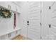 Mudroom with built-in bench seating, storage cabinets, and a welcoming wreath decor at 1149 Rosecliff Dr, Waxhaw, NC 28173