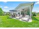 Relaxing outdoor patio with lounge chairs, dining and ceiling fans at 1149 Rosecliff Dr, Waxhaw, NC 28173