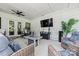 Covered patio with ceiling fan, outdoor furniture, fireplace, and television at 1149 Rosecliff Dr, Waxhaw, NC 28173