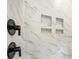 Close up of a shower featuring black fixtures and built in storage at 1149 Rosecliff Dr, Waxhaw, NC 28173