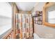 Cozy bathroom featuring a shower with patterned curtain and an organized shelving unit at 1204 N 12Th St, Bessemer City, NC 28016