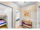 Hallway view with console table and entryways into bedrooms, showcasing layout and design at 1204 N 12Th St, Bessemer City, NC 28016