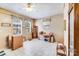 Bright room with a ceiling fan, two windows with floral patterned valances, and tile flooring at 1204 N 12Th St, Bessemer City, NC 28016