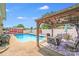 Outdoor seating under a covered pergola next to a refreshing backyard pool at 1204 N 12Th St, Bessemer City, NC 28016