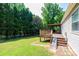 View of wooden deck with steps and ramp leading to the grassy backyard at 1276 Beechwood Dr, Newton, NC 28658