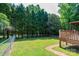 Backyard with wooden deck, a covered pergola and a partial fence at 1276 Beechwood Dr, Newton, NC 28658