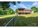 View of the yard, partial fence and lower level of a home with upper level deck at 1276 Beechwood Dr, Newton, NC 28658