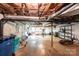Spacious unfinished basement with exposed ceiling and utilities, room for storage, shelving, workshop and projects at 1276 Beechwood Dr, Newton, NC 28658