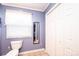 Light purple bathroom with toilet, white blinds, and closet at 1276 Beechwood Dr, Newton, NC 28658