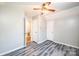 Bedroom with grey walls, updated flooring, and a ceiling fan at 1276 Beechwood Dr, Newton, NC 28658