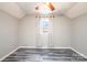This bedroom features gray walls, a modern ceiling fan, new plank flooring and a sunny window with white curtains at 1276 Beechwood Dr, Newton, NC 28658