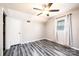 Bright bedroom features gray walls, a ceiling fan, new plank flooring, a closet and a sunny window with white curtains at 1276 Beechwood Dr, Newton, NC 28658
