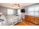 Bedroom featuring hardwood floors, a ceiling fan and a flat-screen tv at 1276 Beechwood Dr, Newton, NC 28658