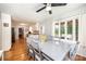 Bright dining room with hardwood floors, modern ceiling fan, and large window views to outside greenery at 1276 Beechwood Dr, Newton, NC 28658