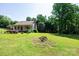 Well-maintained single-story home with green lawn surrounded by mature trees at 1276 Beechwood Dr, Newton, NC 28658