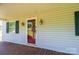 Welcoming front porch features a red door, brass sconces, and ample space for relaxing and enjoying the neighborhood at 1276 Beechwood Dr, Newton, NC 28658