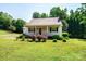 Quaint single-story home featuring a beautifully landscaped front yard with vibrant flower bushes at 1276 Beechwood Dr, Newton, NC 28658