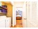 Hallway with laundry machines and a bedroom in the background with wooden floors and a ceiling fan at 1276 Beechwood Dr, Newton, NC 28658