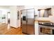 Spacious kitchen featuring hardwood floors, stainless steel refrigerator, and bright white cabinets at 1276 Beechwood Dr, Newton, NC 28658