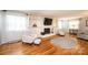 Cozy living room with hardwood floors, built-in shelving, a fireplace, and comfortable seating, creating a relaxing space at 1276 Beechwood Dr, Newton, NC 28658