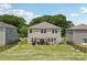 Spacious backyard features a patio with seating, grill, playground, and a lush, green lawn at 15023 Longmoore Dr, Charlotte, NC 28278