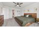 Bedroom with a wood bed frame, neutral walls, carpeted floors, ceiling fan, and a built in bookcase at 15023 Longmoore Dr, Charlotte, NC 28278