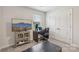 Bright home office featuring a work desk, white closets, and a TV for relaxed productivity at 15023 Longmoore Dr, Charlotte, NC 28278