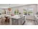Bright kitchen with large island, modern countertops, and an open dining area with natural light at 15023 Longmoore Dr, Charlotte, NC 28278