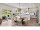Open concept kitchen and dining area with a stylish light fixture and sliding glass doors to a patio at 15023 Longmoore Dr, Charlotte, NC 28278