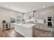 Modern kitchen with white countertops, stainless steel appliances, and hardwood floors at 15023 Longmoore Dr, Charlotte, NC 28278