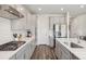 This open kitchen features stainless steel appliances, granite countertops, and gray cabinets at 15023 Longmoore Dr, Charlotte, NC 28278