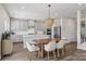 Modern kitchen and dining area with stainless steel appliances, granite counters, and an island at 15023 Longmoore Dr, Charlotte, NC 28278