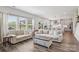 Spacious living room with large windows, hardwood floors, and comfortable neutral-toned furnishings at 15023 Longmoore Dr, Charlotte, NC 28278