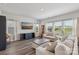 Bright living room featuring hardwood floors, a large sofa, and a view of the outdoors at 15023 Longmoore Dr, Charlotte, NC 28278