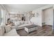 Open-concept living area with hardwood floors, stylish sofas, and seamless flow to the kitchen at 15023 Longmoore Dr, Charlotte, NC 28278