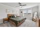 Cozy main bedroom with a wooden bed frame, neutral colors, and natural light at 15023 Longmoore Dr, Charlotte, NC 28278
