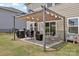 Cozy patio with awning cover, outdoor seating, grill, and play area for backyard fun and relaxation at 15023 Longmoore Dr, Charlotte, NC 28278