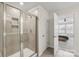 Bright shower featuring tiled walls, and a glass door with a view into the Primary bedroom at 15023 Longmoore Dr, Charlotte, NC 28278